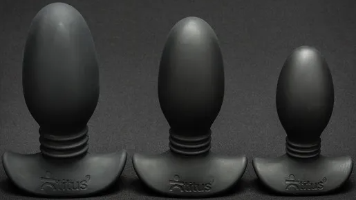 A collection of three egg-shaped black silicone butt plugs