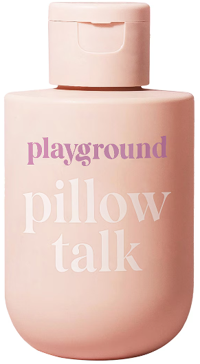 A small cream-colored bottle of Playground brand lube called Pillow Talk