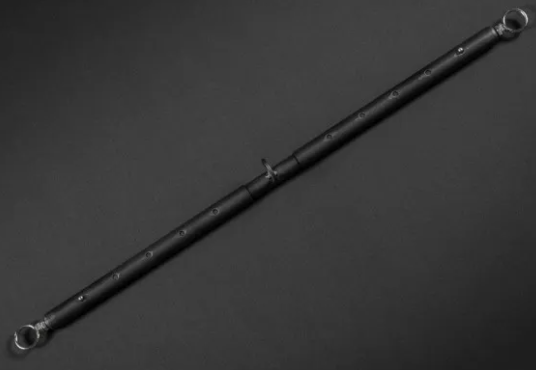 A black metal spreader bar intended to be locked around the ankles