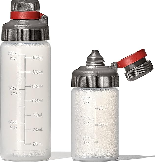 A set of two clear squeeze bottles with attached leak-proof screw caps